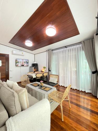 a living room with a couch and a table at Anna River Home A1 in Ban Khlong Si