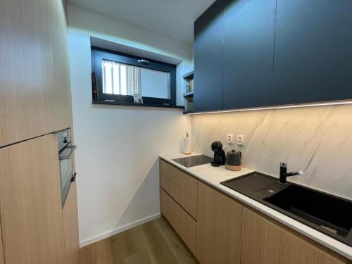 a kitchen with a sink and a counter top at PENATI GOLF Apartment in Šajdíkove Humence