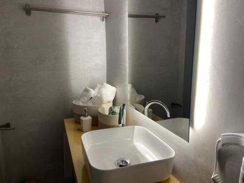 a bathroom with a white sink and a mirror at Seaside Akrata's House in Paralía Akrátas