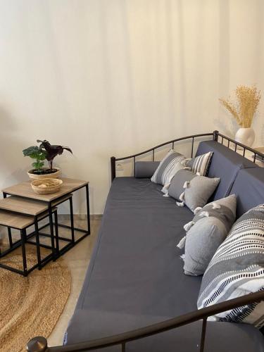 a blue bed with pillows on it in a room at Seaside Akrata's House in Paralía Akrátas