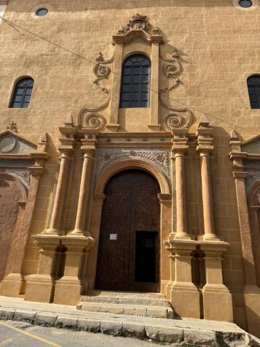 a large building with a large door with columns at Apartamentos Peñaflor in Guadix