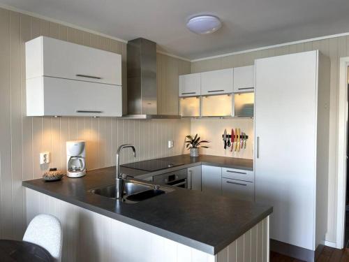 a kitchen with a sink and a counter top at Modern Fisherman Cabin in Ballstad