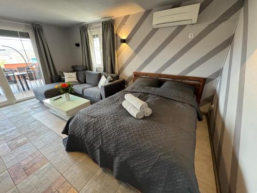 a bedroom with a bed and a living room at Ferienhaus Bilice - Pool beheizt - Fitness - Relax in Bilice