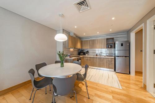 a kitchen and dining room with a table and chairs at Sherwood Suites in Ho Chi Minh City