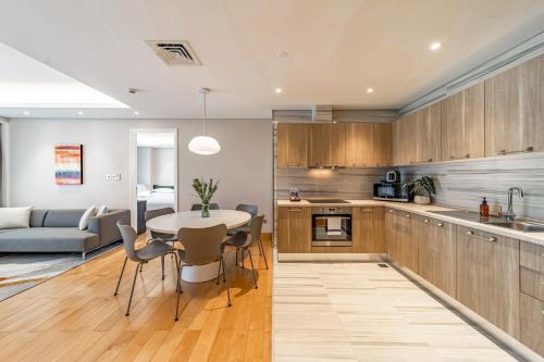 a kitchen and living room with a table and chairs at Sherwood Suites in Ho Chi Minh City