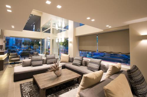 a living room with a couch and a table at Castello City in Patra