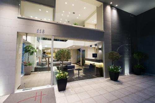 a lobby of a building with furniture and plants at Castello City in Patra