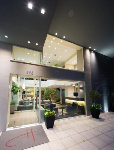 a lobby of a building with couches and plants at Castello City in Patra