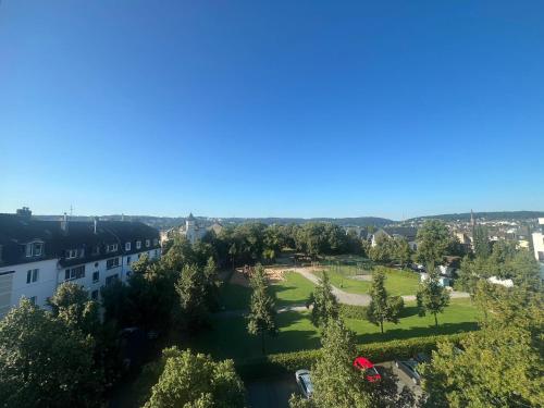 an aerial view of a park with trees and buildings at Wupa Flats in Wuppertal