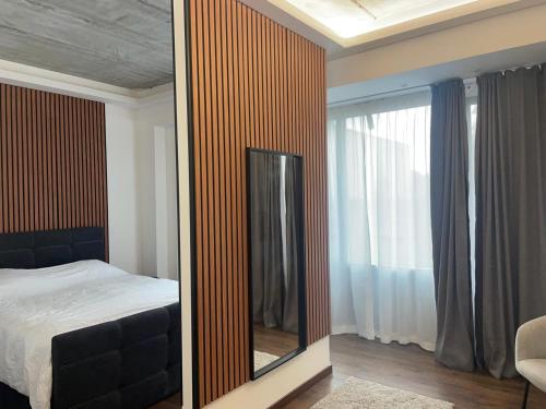 a mirror in a bedroom with a bed and a window at Boutique Diamond Apartments in Antwerp