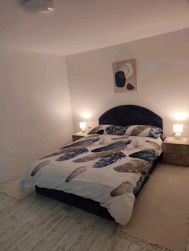 a bedroom with a large bed with two lamps at Gornji Milanovac Apartment in Gornji Milanovac