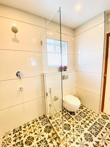 a bathroom with a toilet and a glass shower at The Mohua - A Boutique Hotel in Rānchī