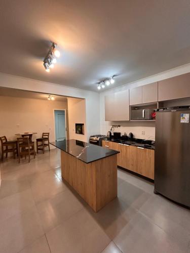 a large kitchen with a island in the middle at Ap Novo Parque Anchieta - Top in Pelotas