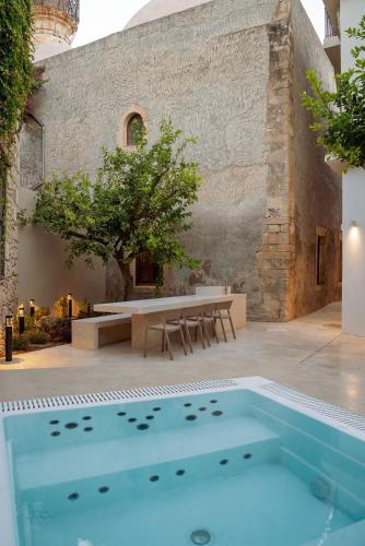 a swimming pool in front of a building at Lemon Garden Villa in Rethymno