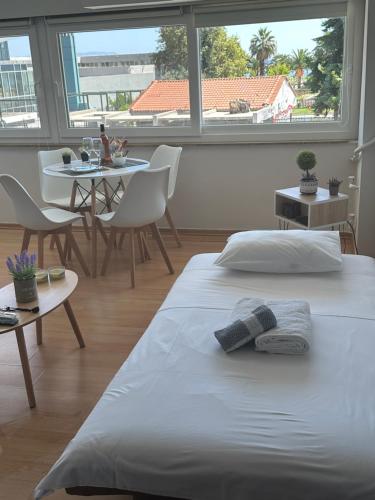 a bedroom with a bed and a table with chairs at Coastal Escape in Kavala