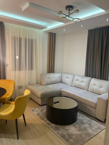 a living room with a couch and a table at Apartman Berg Kopaonik in Kopaonik