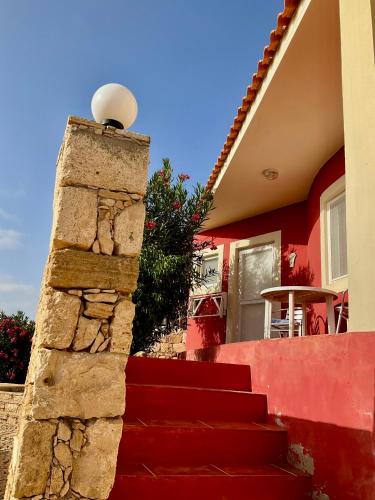 a red staircase leading to a house at Estudio para dos personas-Stella Maris Villa FREE PICK UP in Calheta Do Maio