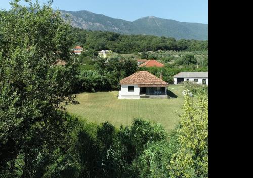 a small white house in a field of grass at Casa L in Ulcinj
