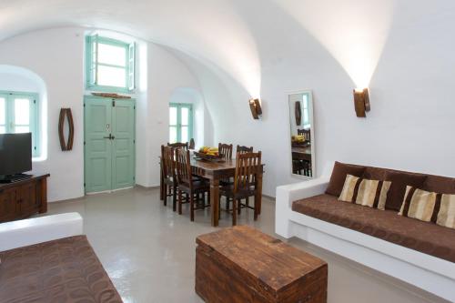 a living room with a couch and a table at Cavern House Anthea in Éxo Goniá