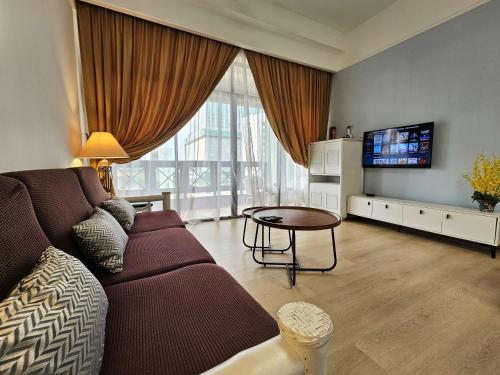 a living room with a couch and a tv at Good2Stay Apartment 6-8pax l 3R2B l 2 Parking l Coway Water l Unifi I Swimming Pool in Melaka