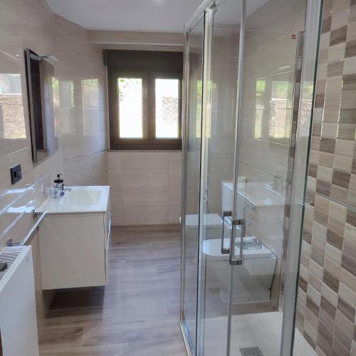 a white bathroom with two sinks and a shower at O Lar da Crega in O Pino 