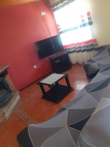 a living room with a couch and a table at Os Girassóis da Carla in Braga