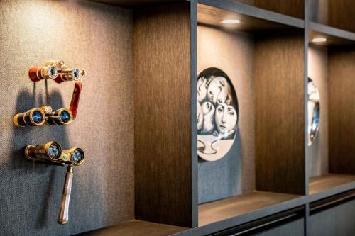 a locker room with a bunch of locks and a mirror at Motel One Berlin Ku'Damm in Berlin