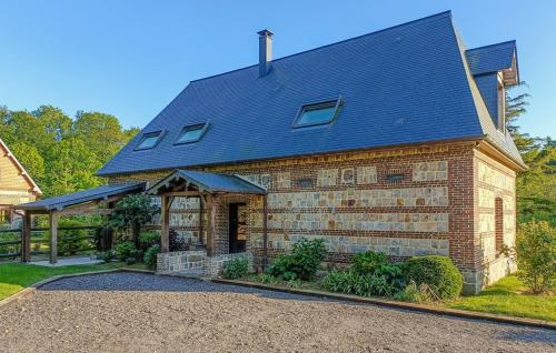 a brick house with a gambrel roof at DOMAINE DE JANVILLE in Paluel