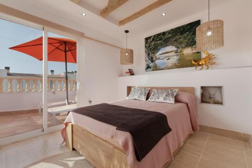 a bedroom with a bed and a balcony at Las Arenas Family in Costa Calma