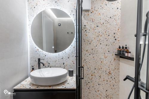a bathroom with a sink and a mirror at Athena & Phevos Luxury Suite With View In Nea Makri in Nea Makri