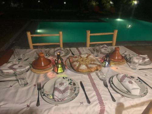 a table with plates of food and utensils on it at green eden palace in Marrakech