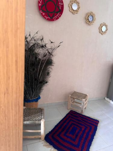 a room with a potted plant and a clock on the wall at green eden palace in Marrakech