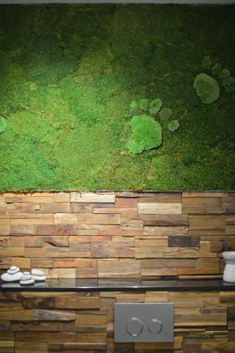 a painting of a field of grass on a wall at La Couette de l'Ours in Aywaille