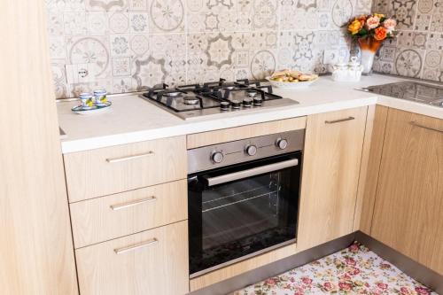 a kitchen with a stove top oven in a kitchen at La casa di Metis in Agerola