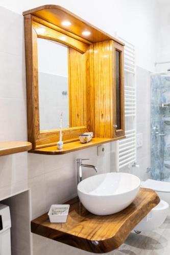 a bathroom with a white sink and a window at La casa di Metis in Agerola