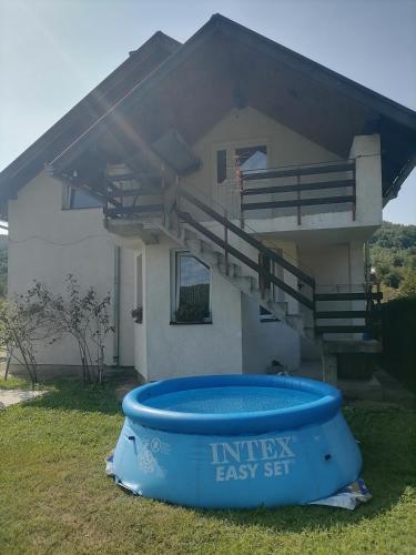a house with a large tub in front of it at Kuća za odmor IN Bajina Basta in Bajina Bašta