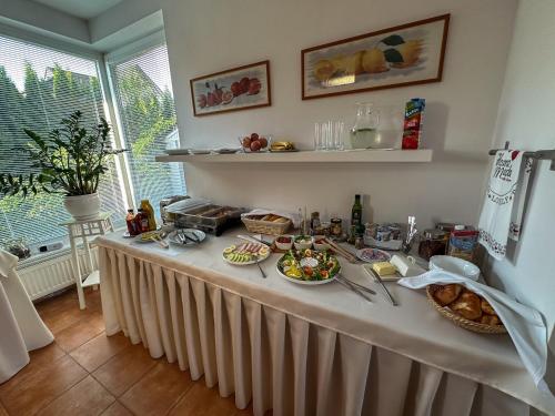 a table with food on it in a kitchen at Penzion Rysy in Veľká Lomnica