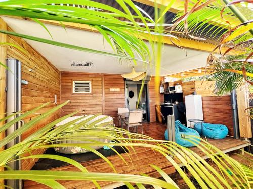 a room with wooden walls and a plant at Villa Moai 974 in Saint-Leu