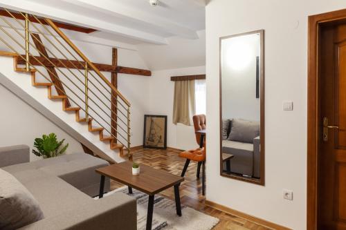 a living room with a couch and a table at Prenoćište Omega Luxury in Čačak
