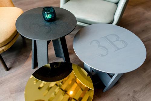 two tables with a candle on top of them in a room at Motel One Berlin-Hauptbahnhof in Berlin