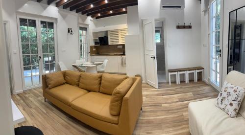 a living room with a couch and a kitchen at Little Oasis in Baška
