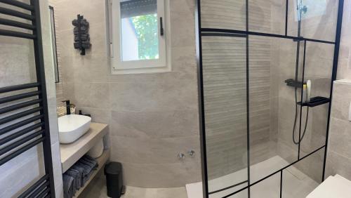 a bathroom with a shower and a sink at Little Oasis in Baška