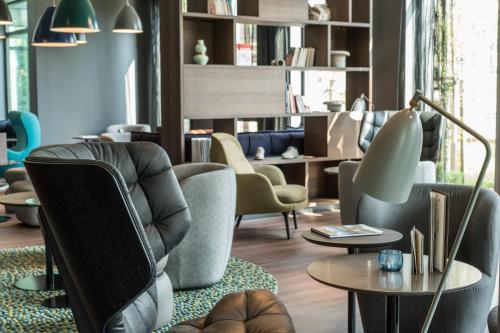 a living room with chairs and a table at Motel One Dresden - Palaisplatz in Dresden