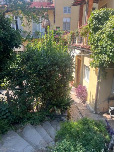 an alley in a building with bushes and trees at Hotel Villa Liana in Florence