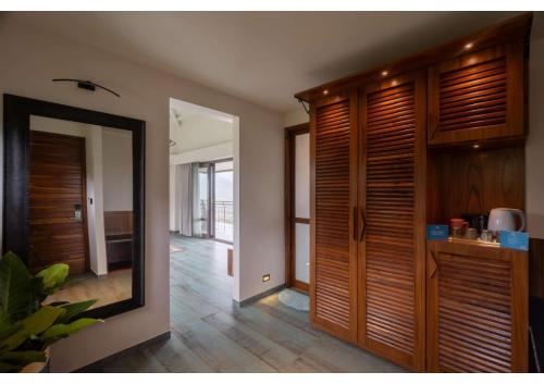 a room with a mirror and a hallway at Malhar Machi Mountain Resorts in Mulshi
