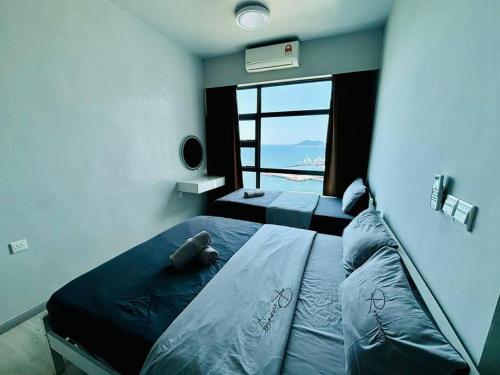 a bedroom with a bed with a view of the ocean at Nerv Seaview T1-22 in Kota Kinabalu