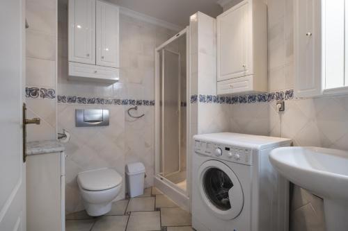a bathroom with a washing machine and a sink at Bloque 76 in Torrox
