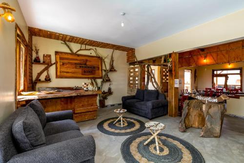 a living room with two couches and a table at Kigarama Wilderness Lodge Mburo in Bakijurura