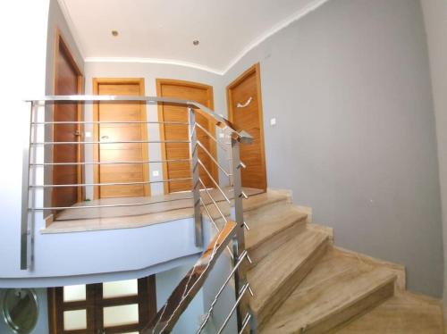 a spiral staircase in a house with wooden doors at Casa Villa Molins in Valencia