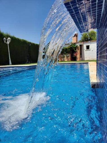 a water fountain in the middle of a swimming pool at Casa Villa Molins in Valencia